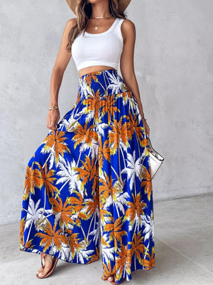 Bohemian print smocked waist wide-leg pants in royal blue with palm trees.