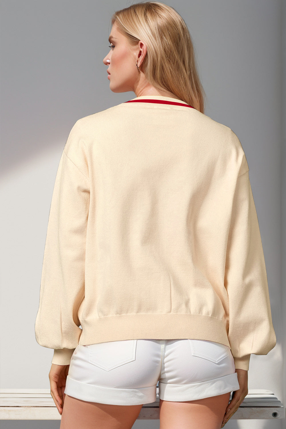 Cream acrylic cardigan with red trim and balloon sleeves