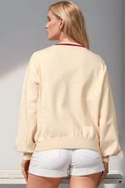 Cream acrylic cardigan with red trim and balloon sleeves