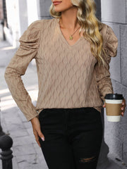 Mocha knit sweater with wave stitch pattern, V-neck, and puff sleeves.