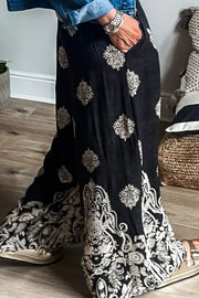 Black palazzo trousers with a damask print and wide legs.