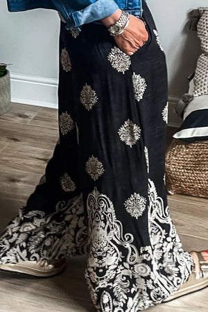 Black palazzo trousers with a damask print and wide legs.