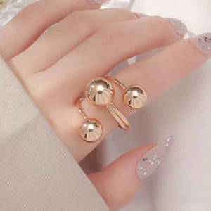 Gold multi-layered ball ring with adjustable alloy band.