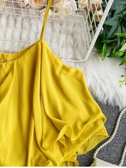 Yellow ruffled camisole with spaghetti straps and delicate ruffles.