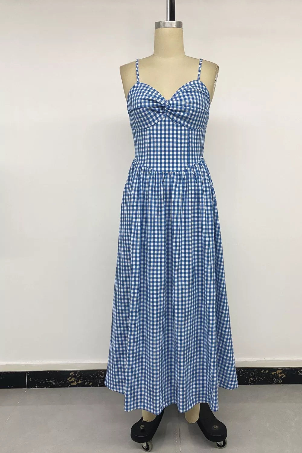 Blue gingham midi dress with spaghetti straps and a knot-front bodice.