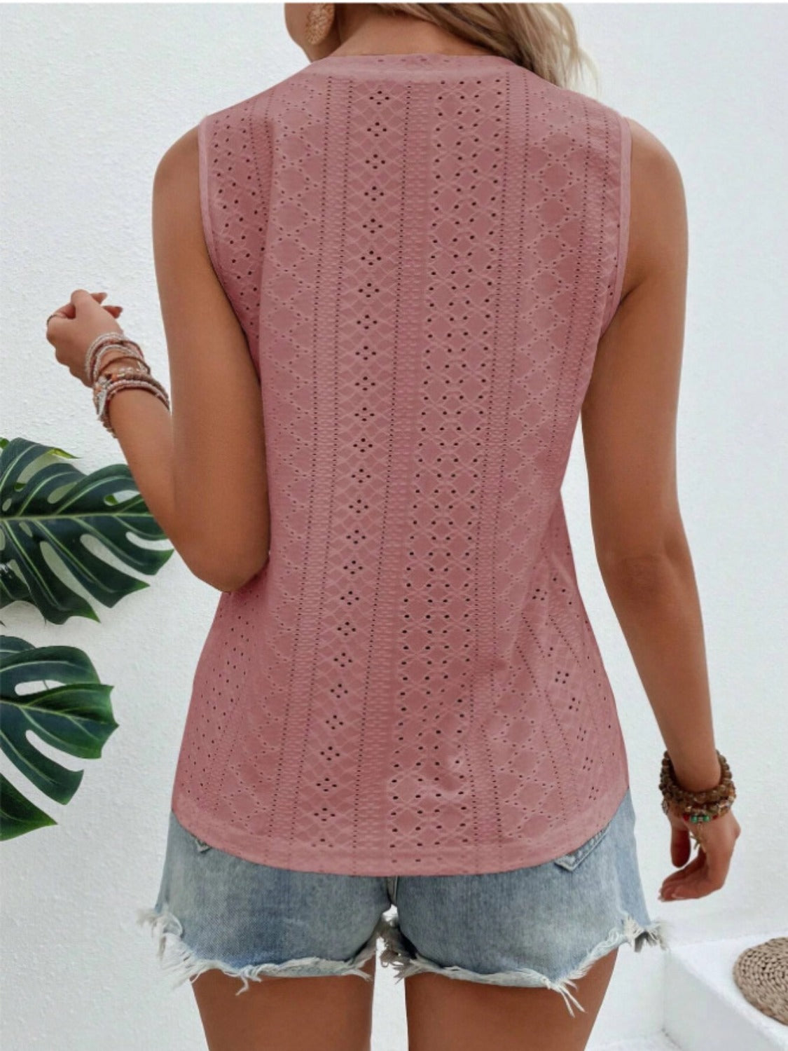 Dusty pink sleeveless eyelet detail top with a V-neck and casual fit.