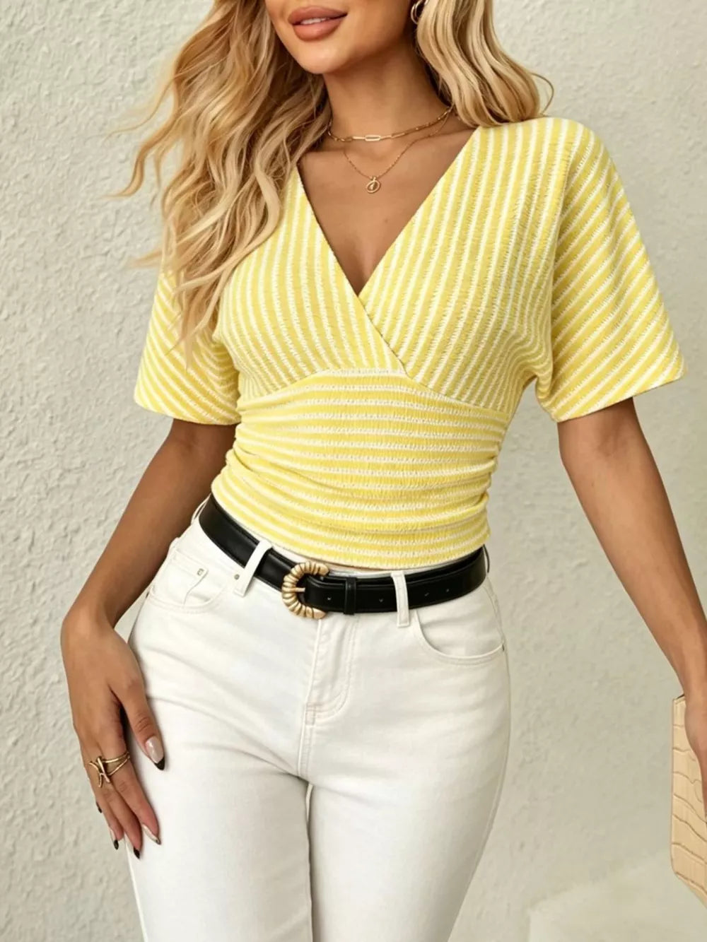 Yellow striped t-shirt with surplice neckline, batwing sleeves, and smocked waist.