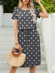 Gray polka dot midi dress with drawstring waist and short sleeves.