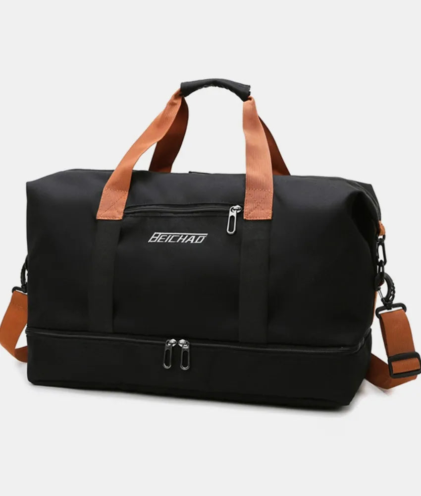 Black dual-compartment weekender bag with contrast brown straps and a zippered bottom compartment.