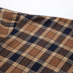 Oversized brown plaid button-up shirt jacket with a classic checkered pattern.