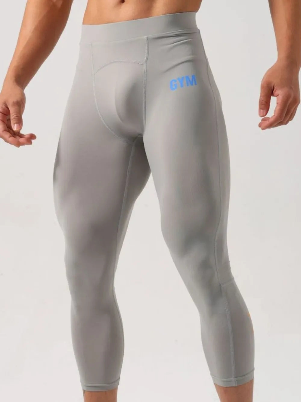 Gray compression capri pants with blue GYM logo detail