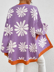 Floral jacquard knit cardigan in lavender with white daisies and orange trim.
