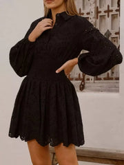 Black eyelet mini dress with balloon sleeves and smocked waist