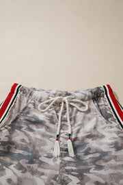 Maternity camo print relaxed fit pants with drawstring and red stripe detail.