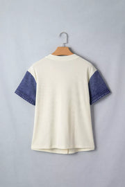 Cream ribbed knit maternity shirt with short denim sleeves and button details.