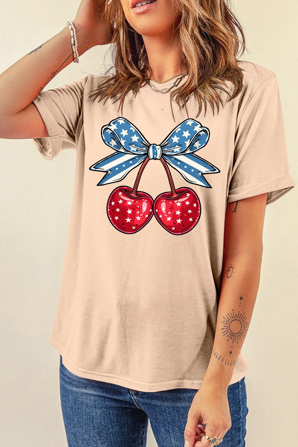 Tan graphic t-shirt with patriotic cherry and star bow design.