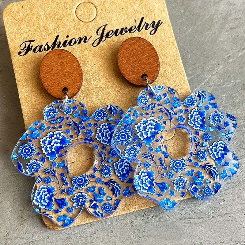 Floral acrylic drop earrings with blue chinoiserie pattern and wooden tops.