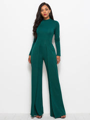 Dark green high-waisted palazzo jumpsuit with slit front and long sleeves.