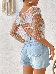 White crochet cardigan with metallic threads, open knit, and cutout back detail.