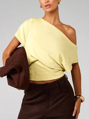 Yellow asymmetrical crop t-shirt with draped fit and short sleeves.