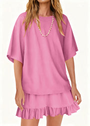 Light pink ruffled tee and skirt set with relaxed fit and short sleeves.