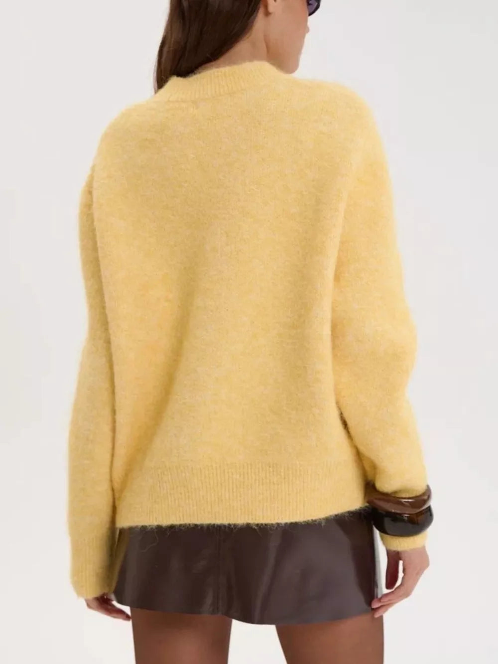 Cozy knit sweater in pastel yellow with relaxed fit and crew neck.