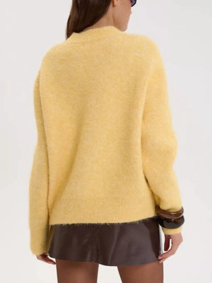 Cozy knit sweater in pastel yellow with relaxed fit and crew neck.