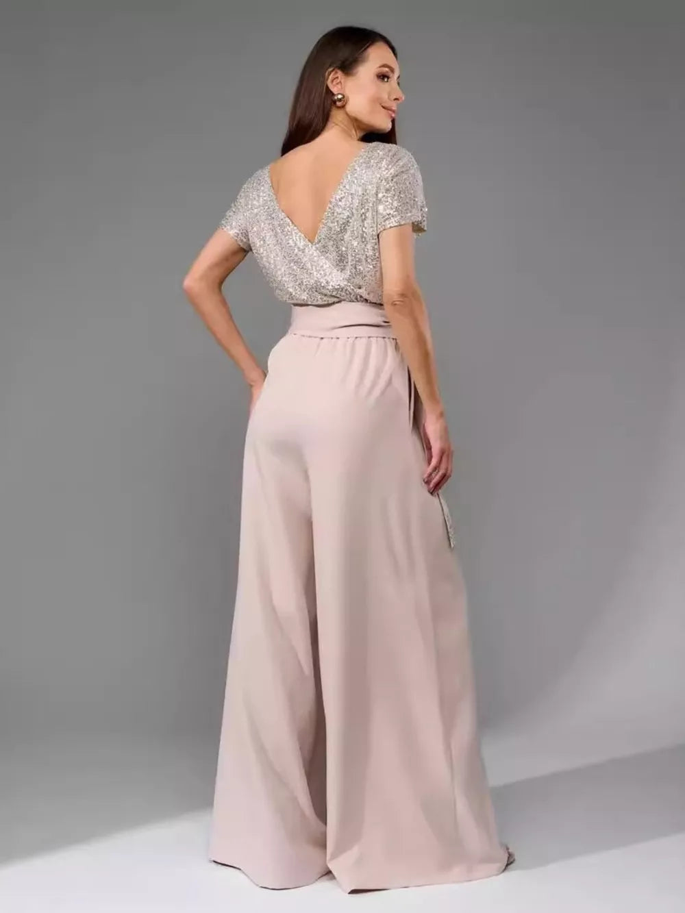 Shimmering sequin wide-leg jumpsuit with tie in apricot silver and pale pink polyester.