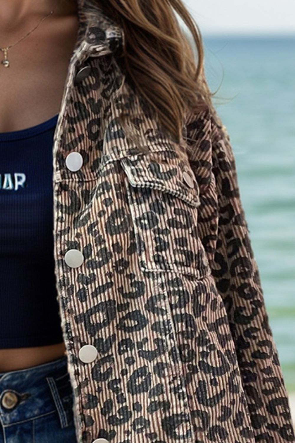 Leopard print corded cropped jacket with button front and chest pockets.