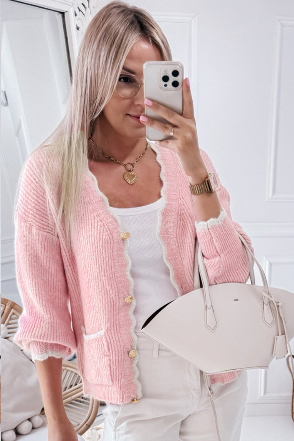 Blush pink bouclé cardigan with scalloped trim and gold buttons.