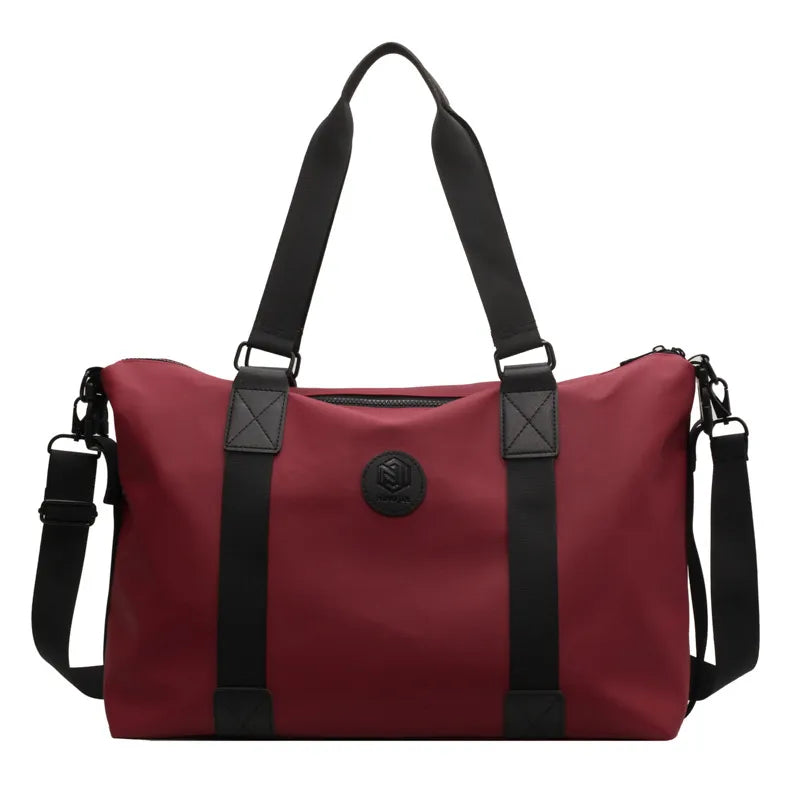 Burgundy duffel bag with black straps and logo emblem, perfect for gym or travel.