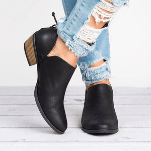 Black V-cut pointed toe block heel boots with cutout sides and lace detail.