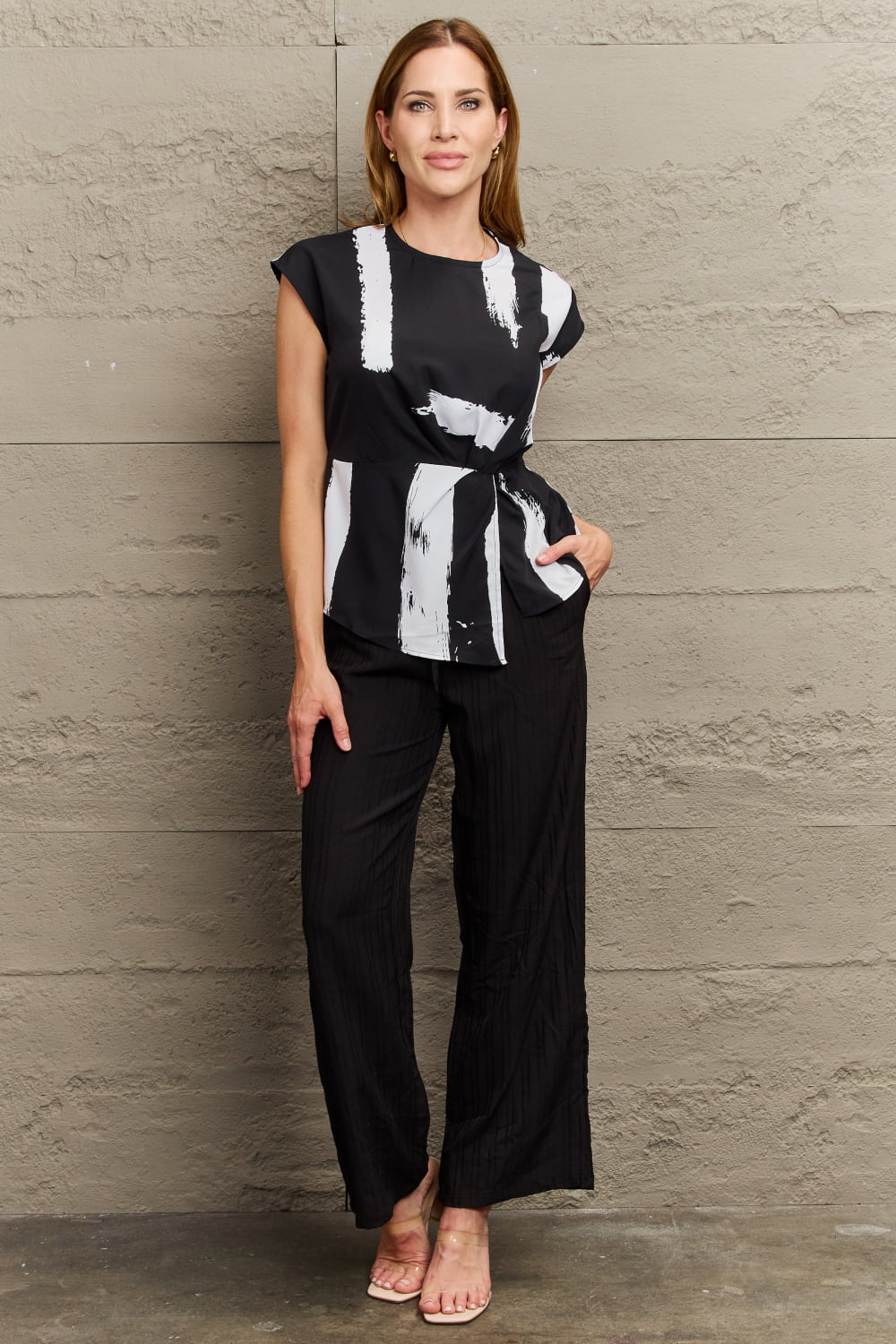Black and white brushstroke print tie-waist blouse with cap sleeves.