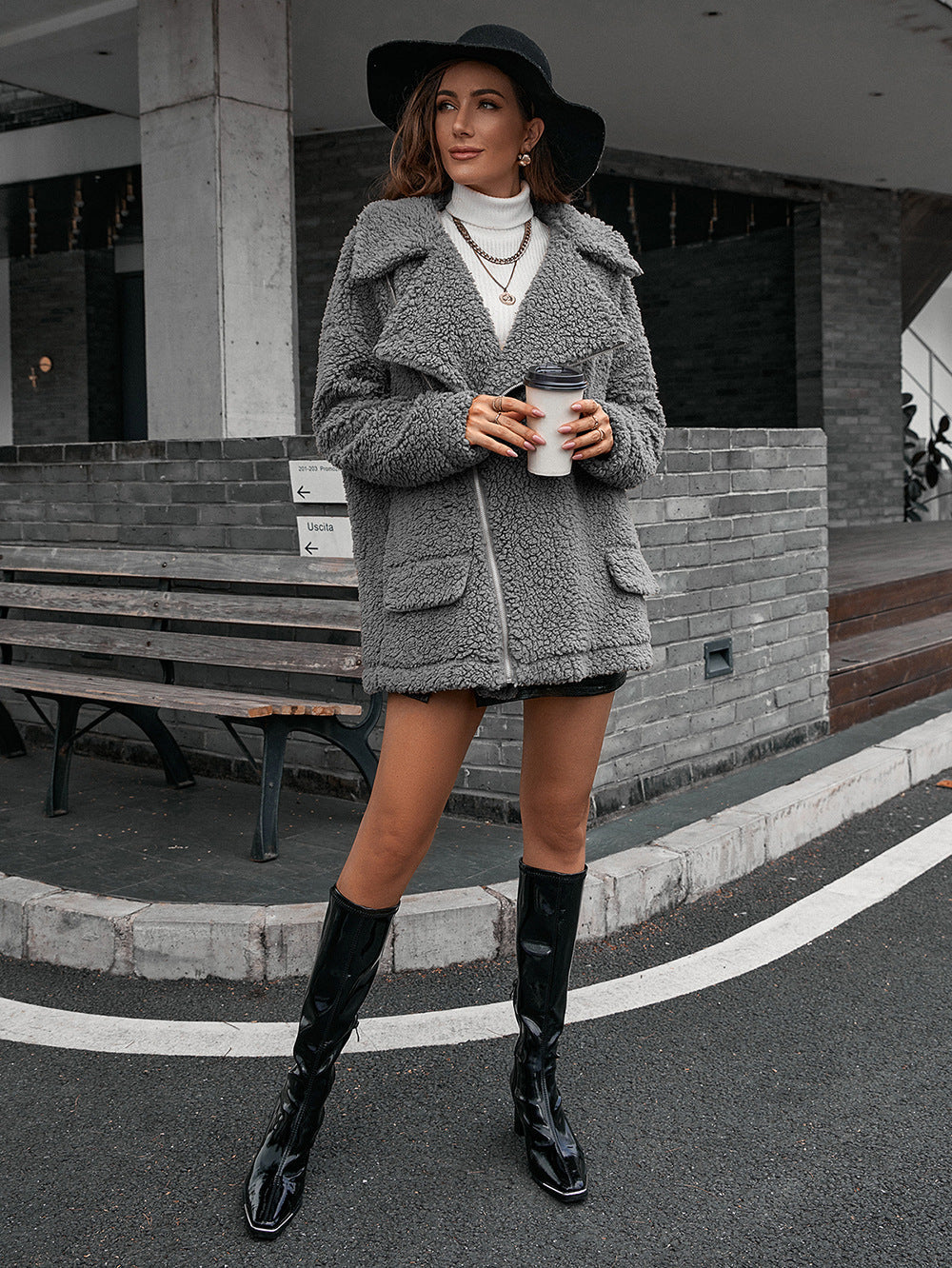 Gray teddy moto jacket with asymmetrical zip and collared neckline.