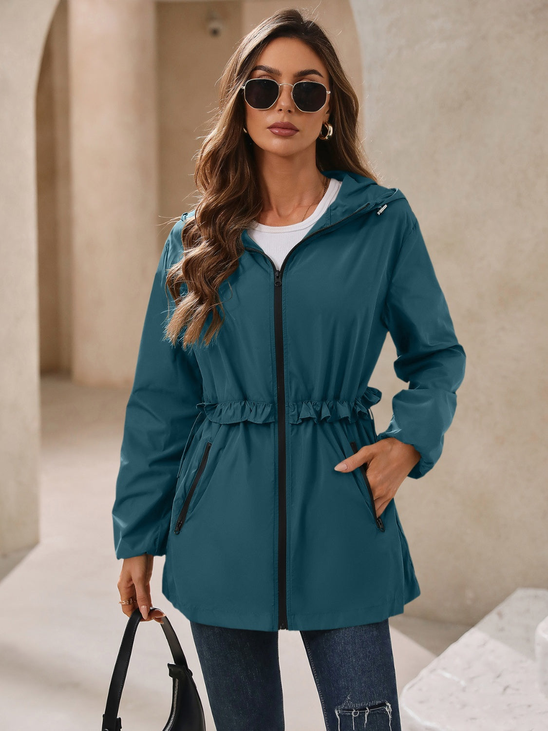 French blue hooded windbreaker jacket with ruffled waistline and zip pockets
