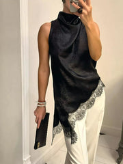 Black asymmetrical cami top with lace trim and draped neckline.