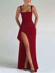 Red body hugging maxi dress with square neckline, spaghetti straps, and high slit.