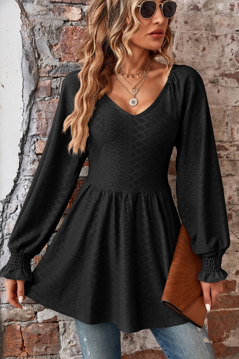 Black textured empire waist blouse with shirred sleeves and v-neck