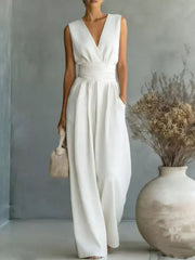 White sleeveless wide-leg jumpsuit with V-neck, cinched waist, and pockets.