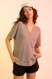 Taupe waffle knit v-neck top with short sleeves and a chest pocket.