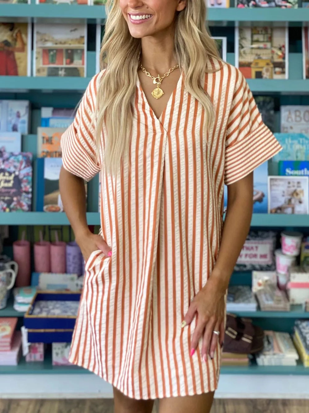 Striped V-neck shift mini dress with short sleeves and pockets.