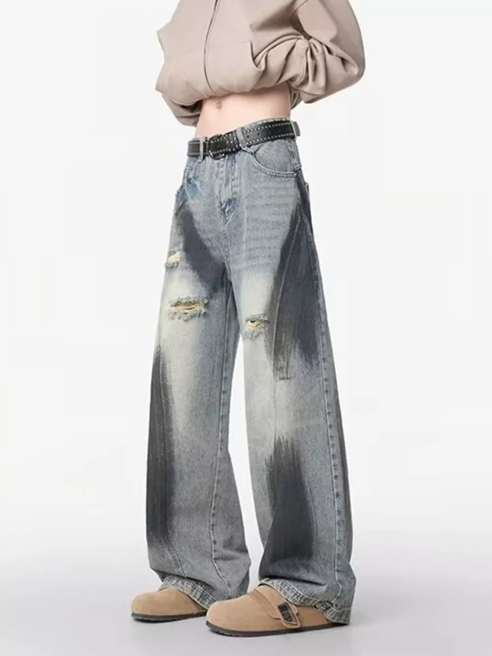 Distressed wide-leg jeans with belted detail and dark wash accents.