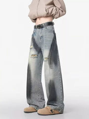 Distressed wide-leg jeans with belted detail and dark wash accents.