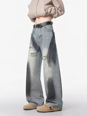 Distressed wide-leg jeans with belted detail and dark wash accents.