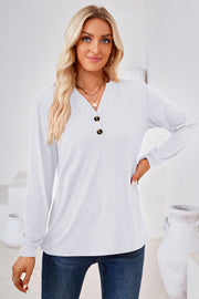 White henley neckline jersey top with button detail and long sleeves.