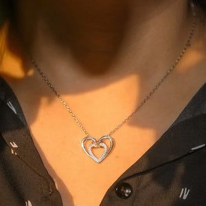 Silver double heart infinity pendant necklace with small stones on inner heart