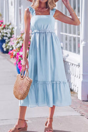 Light blue ruffle-trimmed maternity dress with square neckline and tiered skirt.