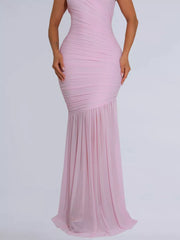 Blush pink ruched bodycon maxi dress with a draped bodice and flowing skirt.