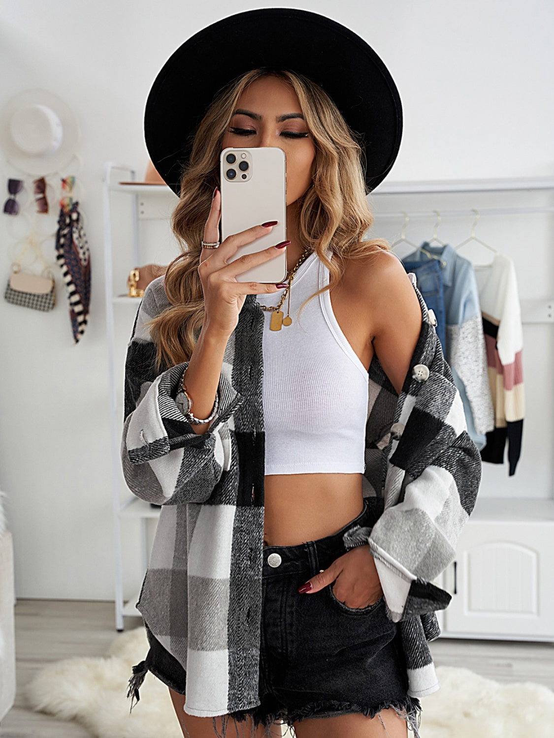 Oversized checkered shacket in black and white with button-down front and patch pocket detail.