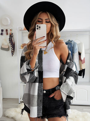 Oversized checkered shacket in black and white with button-down front and patch pocket detail.